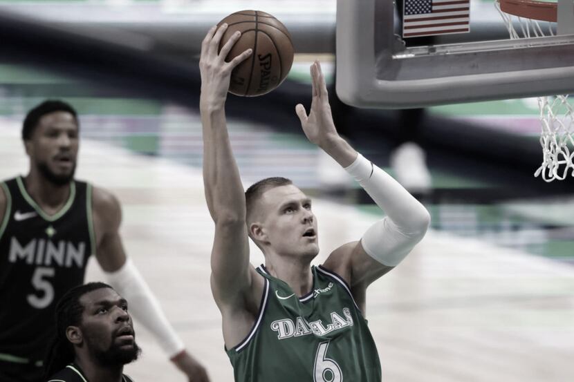 Dallas Mavericks forward Kristaps Porzingis (6) goes up for a dunk as Minnesota Timberwolves...