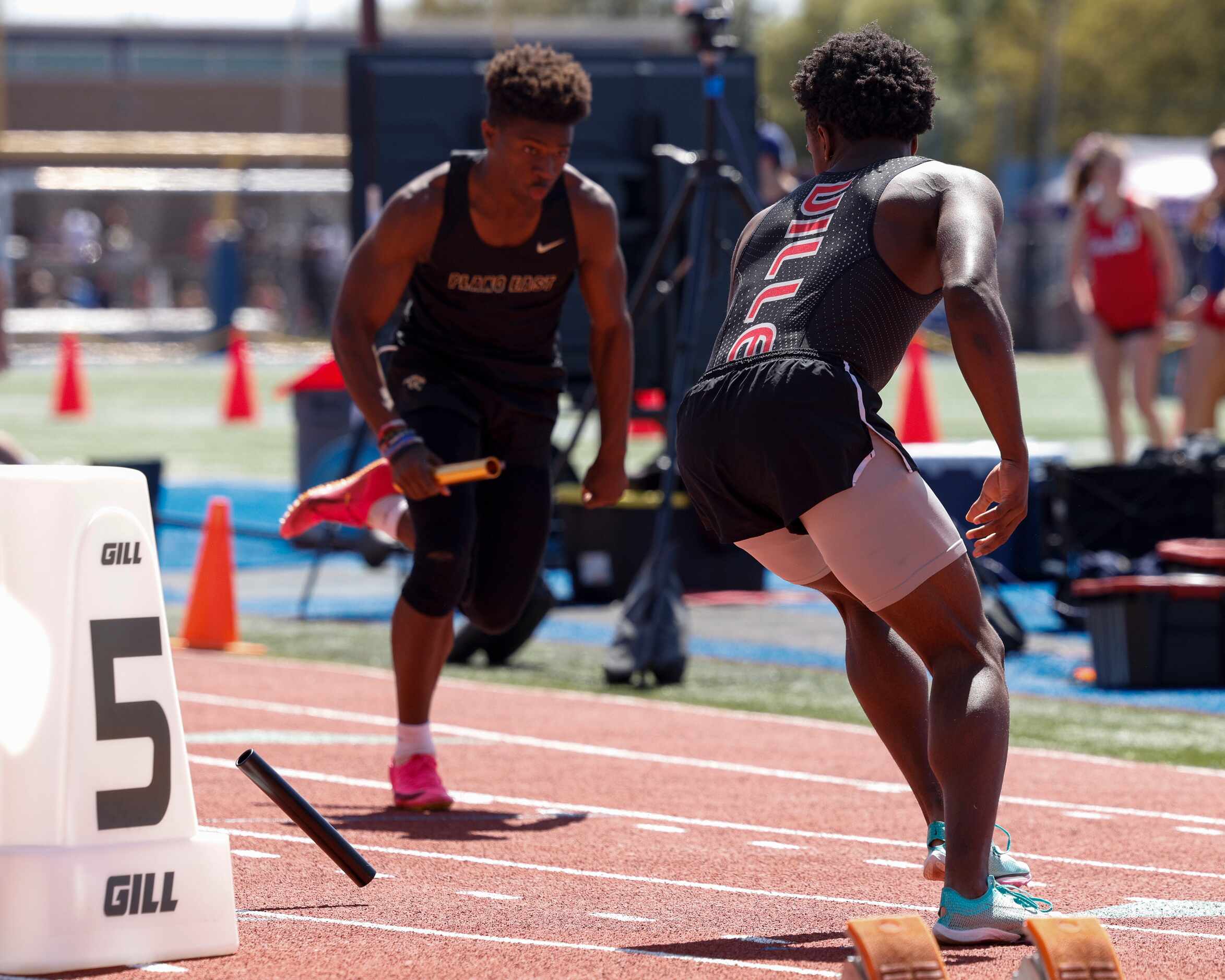Duncanville’s Elijah Beal drops the baton at the start of the 6A boys 4x100 race during the...