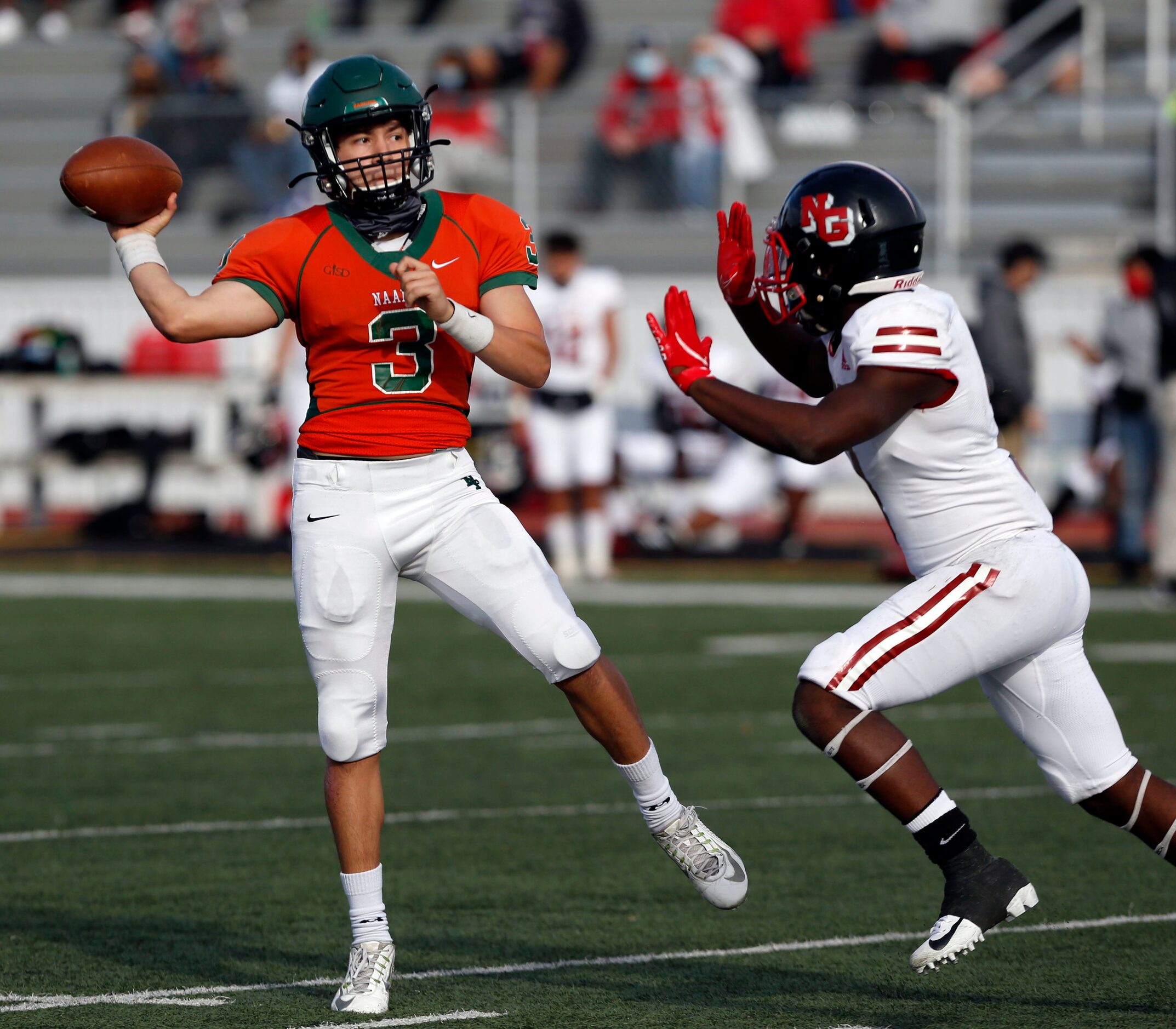 Naaman Forest QB Austin Valdez (3) throws a touchdown pass under pressure from a North...