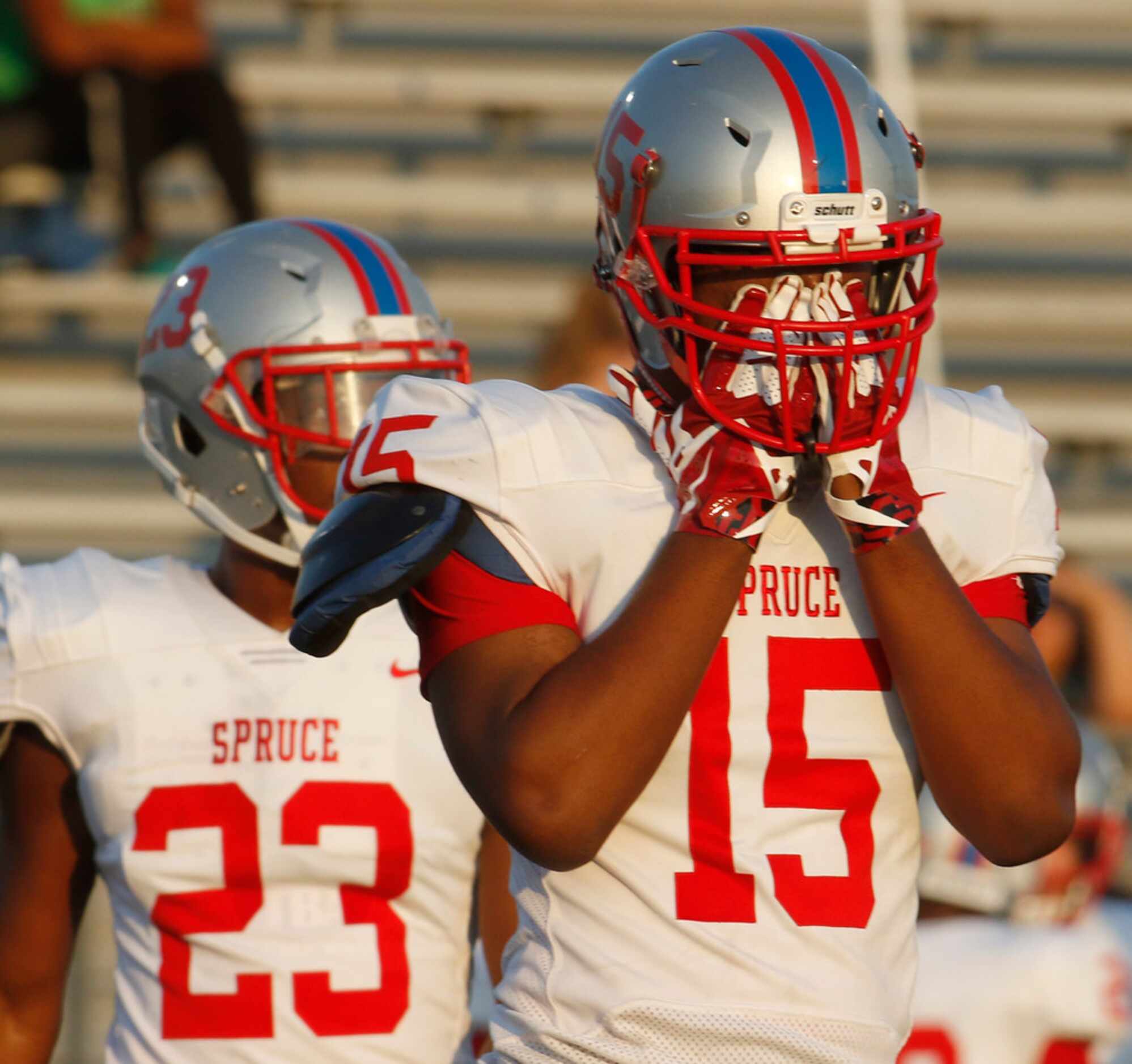 Spruce defensive end LaQuann Johnson (15) wipes the perspiration from his eyes during the...