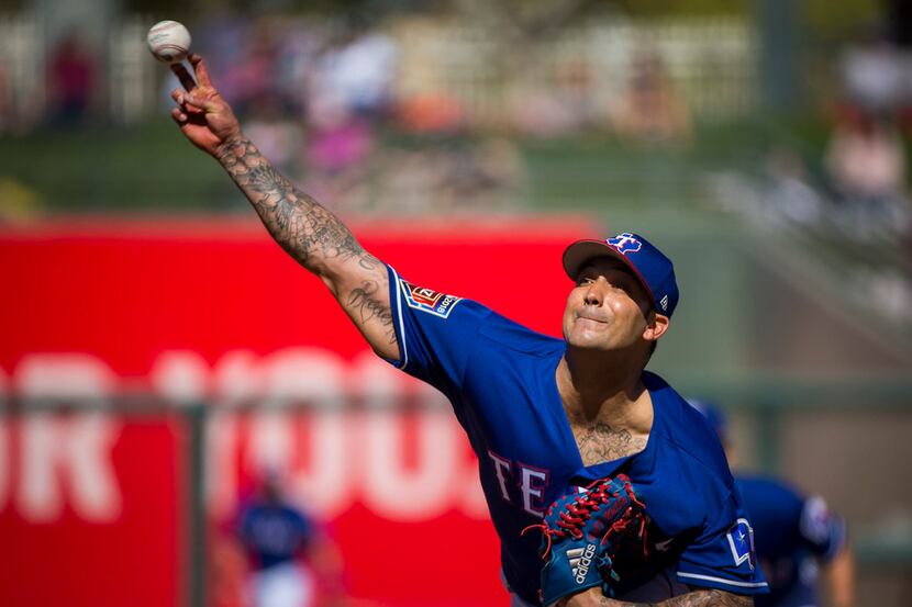 Texas Rangers pitcher Matt Bush pitches during the sceond inning of a spring training...