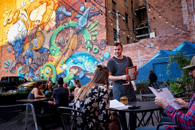 Customers sit on the back patio of the Paramount Ballroom, one of the more hip places to be...