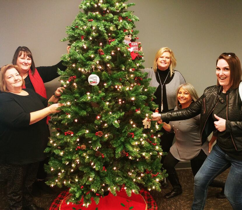 Premier Nationwide Lending workers each brought an ornament to decorate the office tree for...