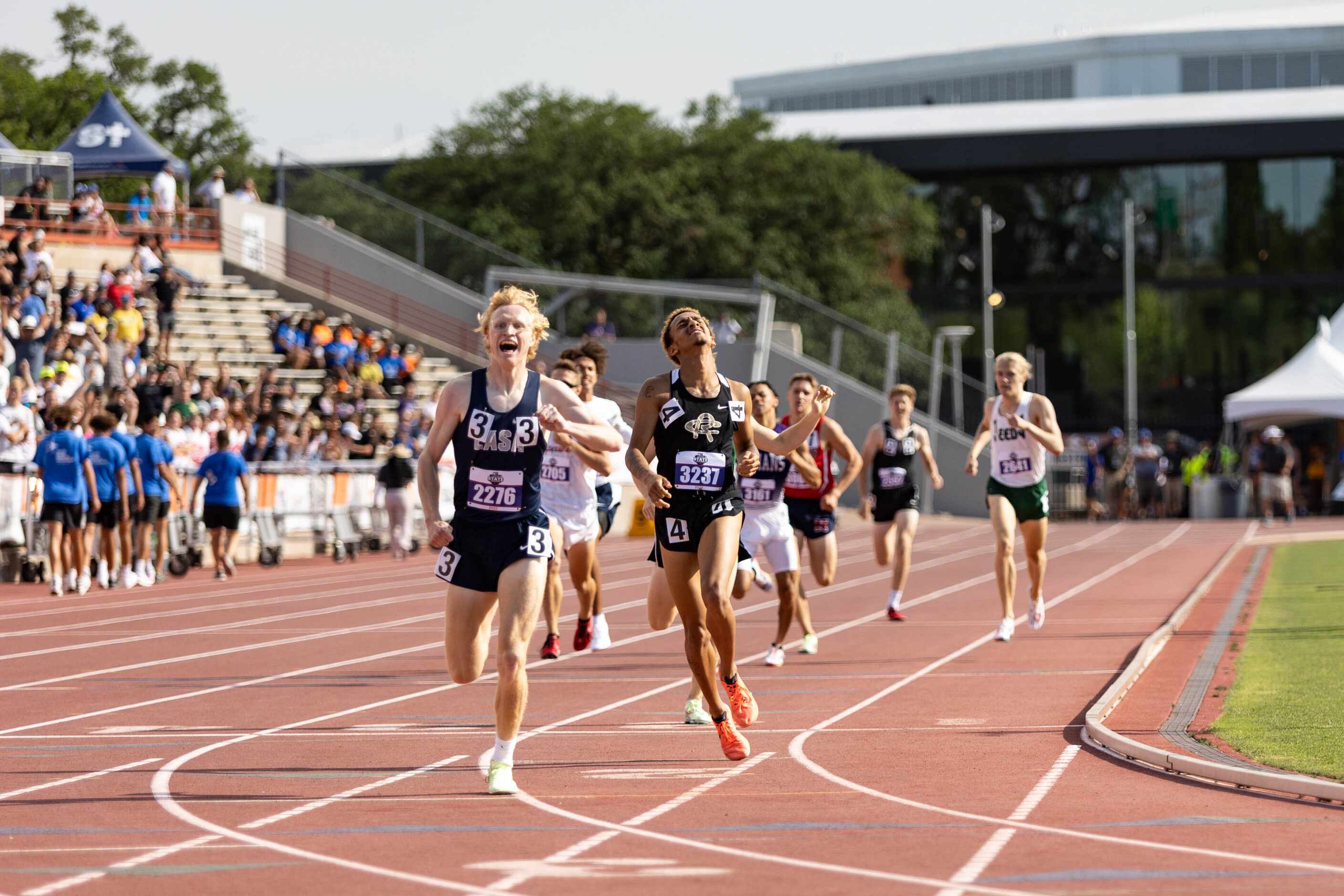 Chasetin Winston of Royse City, in hip number 4, reacts at the finish line of the boys’ 800m...