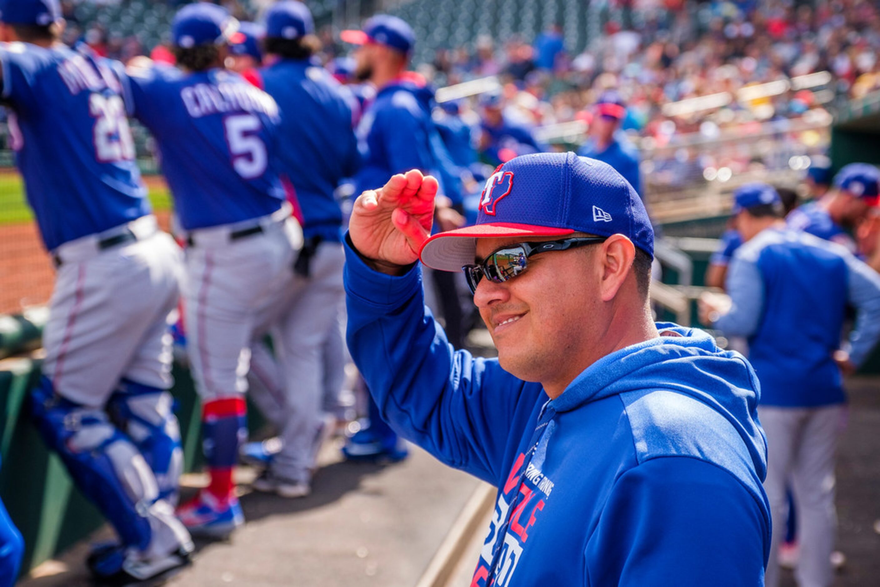 Texas Rangers pitching coach Julio Rangel salutes Cleveland Indians third base coach Mike...