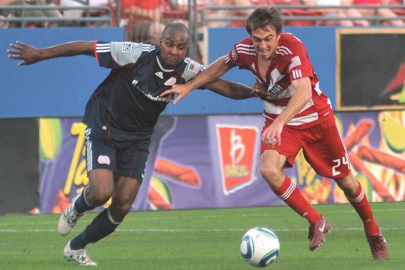 Revolution's Didier Domi (3) pulls on FC Dallas' Eric Alexander (24) jersey as both race for...