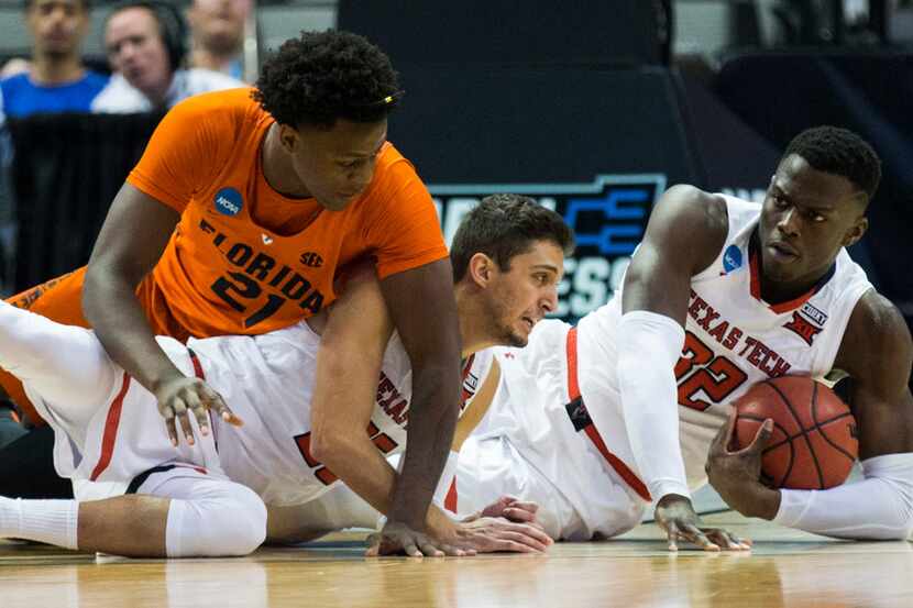 Texas Tech Red Raiders center Norense Odiase (32) and guard Davide Moretti (25) reach for a...