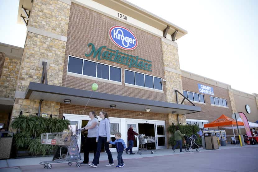 Shoppers walk through the entrance of the Kroger Marketplace in Prosper.