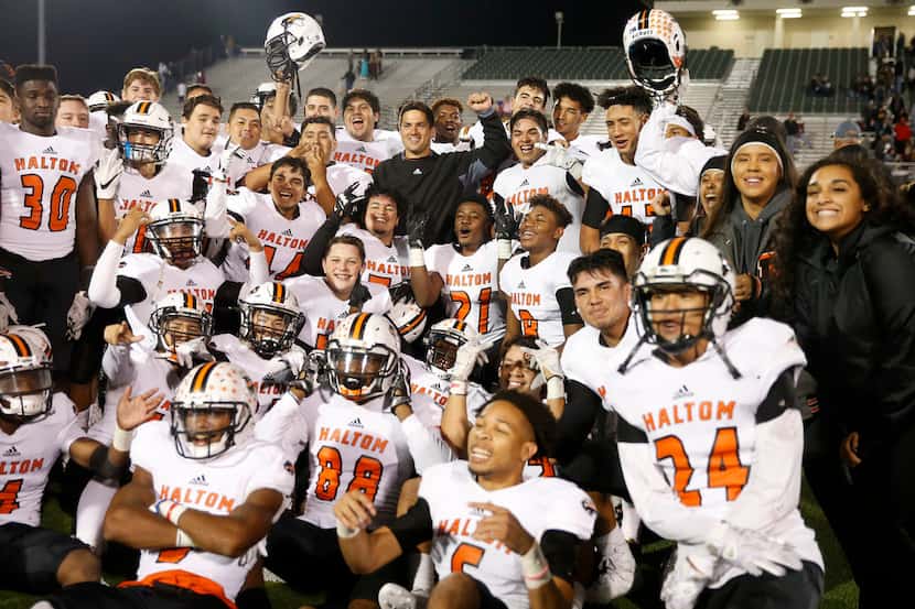 Haltom coach Jason Tucker and his players pose for photographs after defeating Keller...