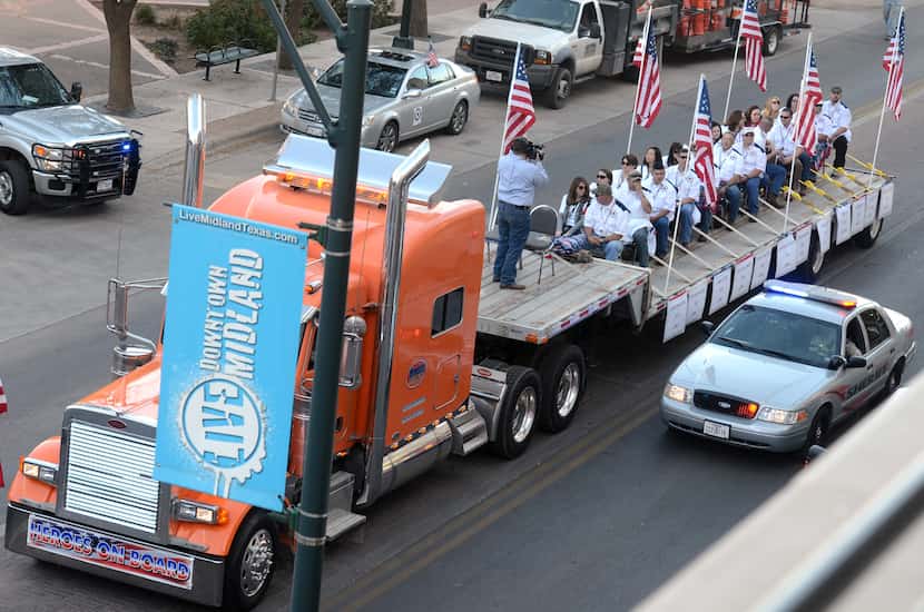 A flatbed truck carries wounded veterans and their families during a parade before it was...