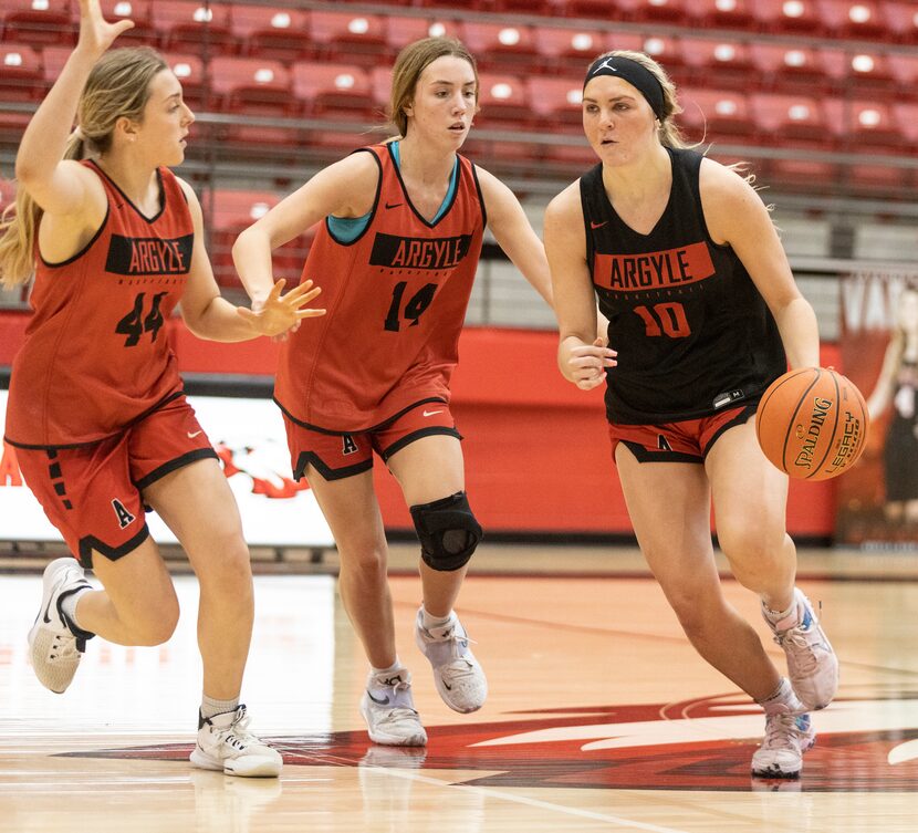 Argyle High School senior, Caroline Lyles, dribbles the ball during a drill at practice on...