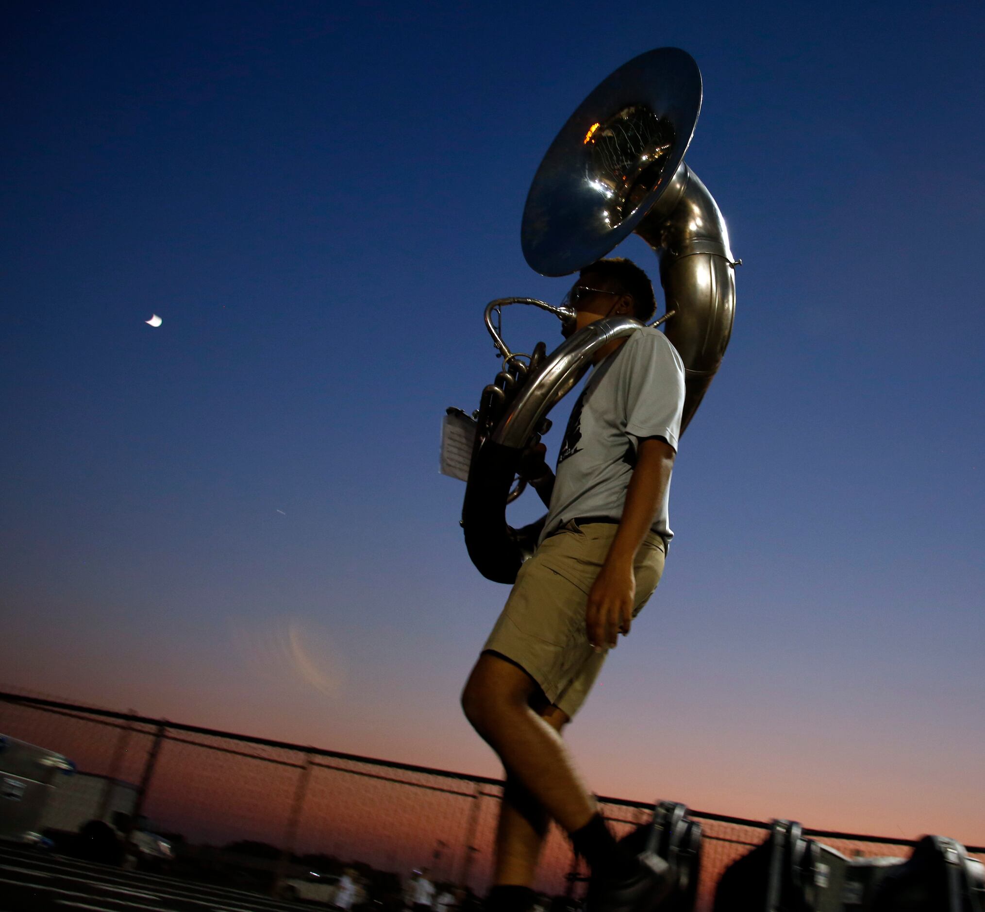 A Red Oak band member makes his way to the field just prior to halftime of the Red Oak...