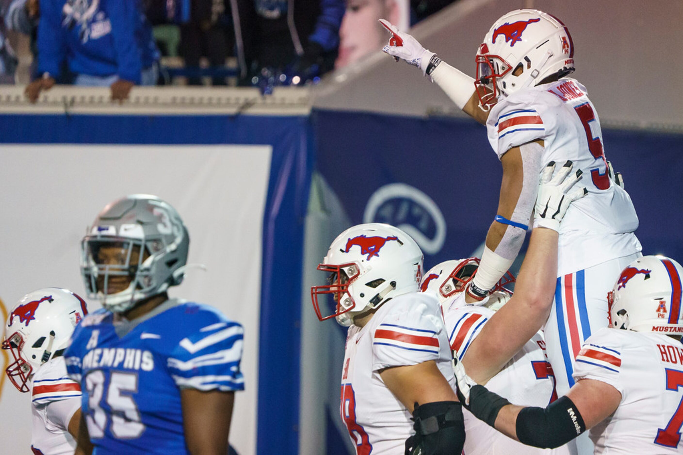 SMU running back Xavier Jones (5) celebrates with offensive lineman Beau Morris (78) after...