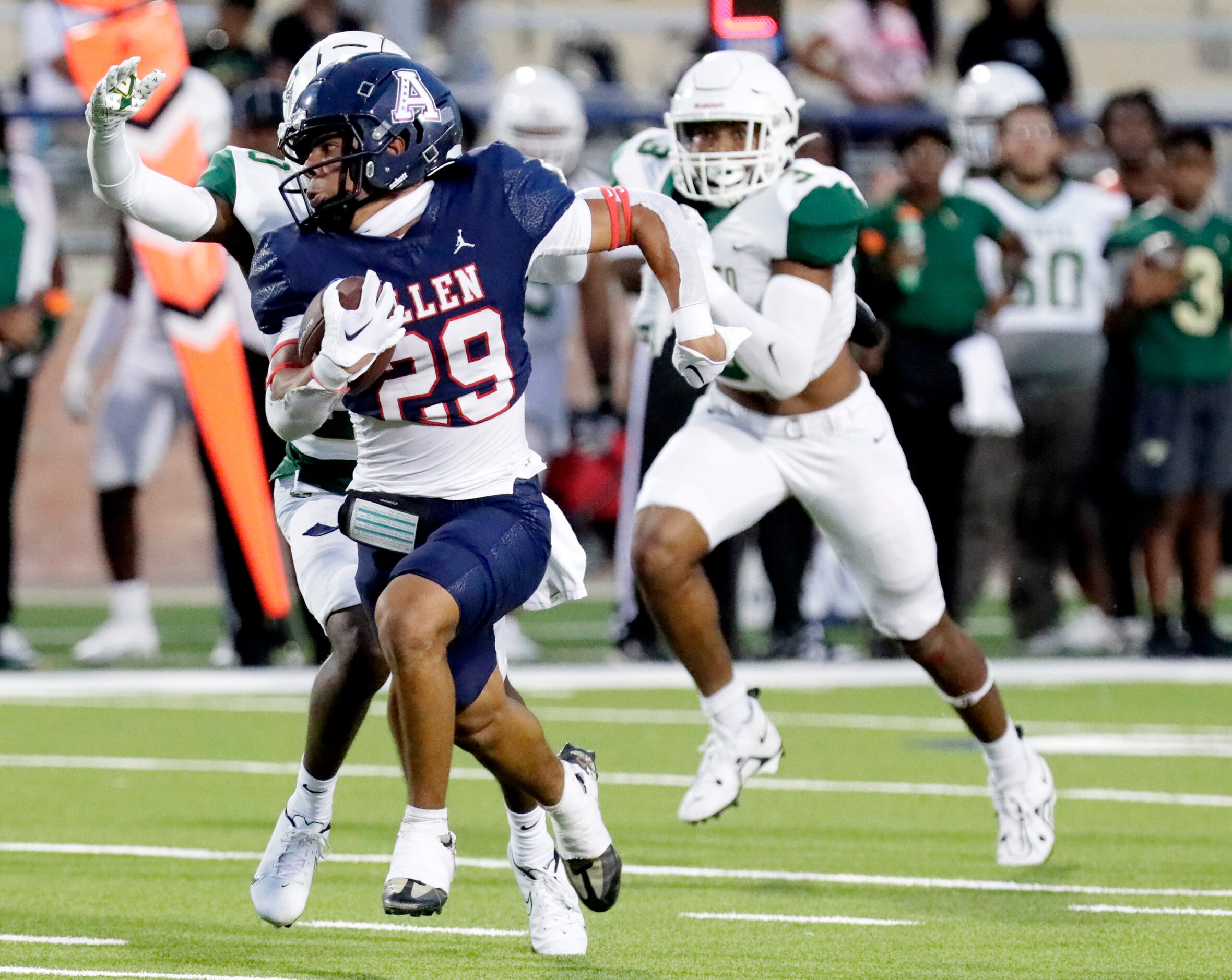 Allen High School running back Jaxon Lyons (29) looks back as DeSoto High School cornerback...