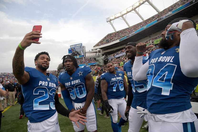 NFC defensive back Darius Slay (23), of the Detroit Lions, records with his phone before the...
