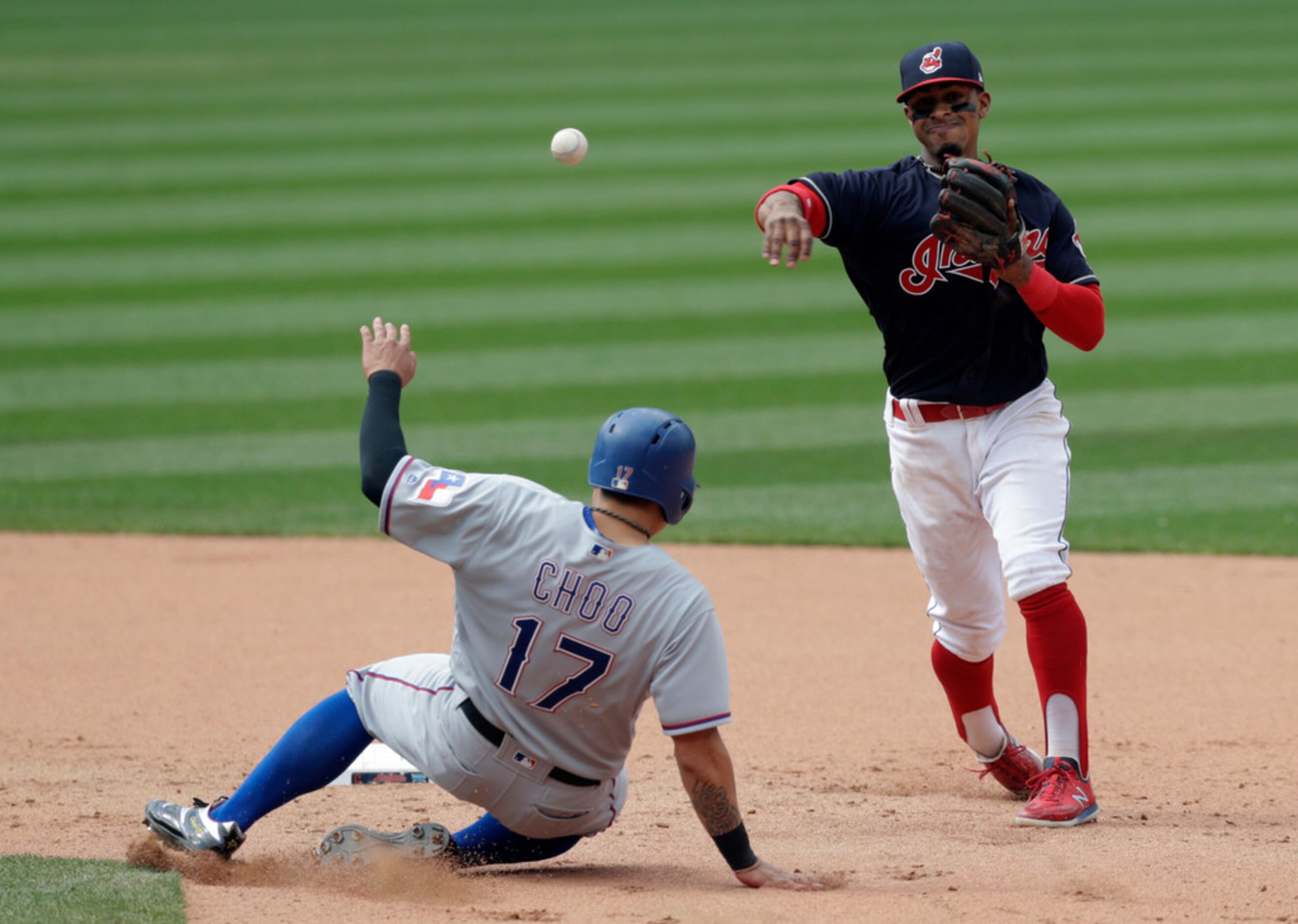 Cleveland Indians' Francisco Lindor throws to first base after getting Texas Rangers'...