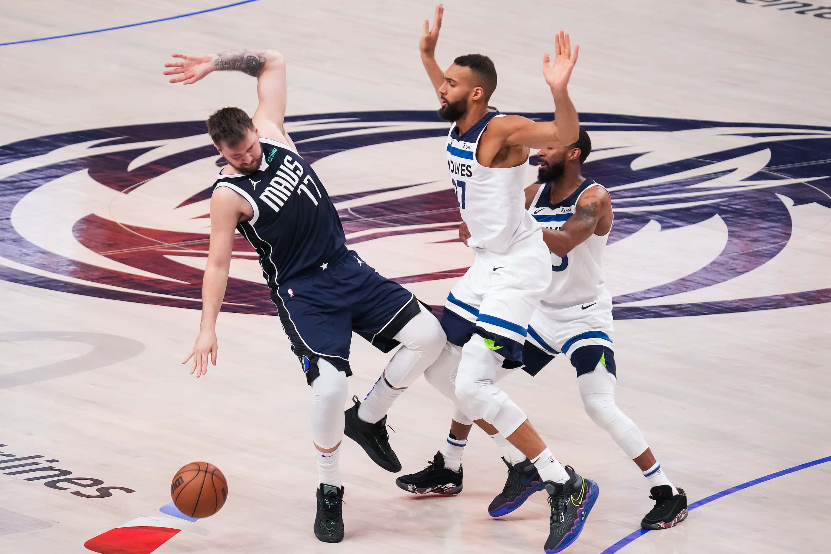 Dallas Mavericks guard Luka Doncic (77) is fouled by Minnesota Timberwolves center Rudy...