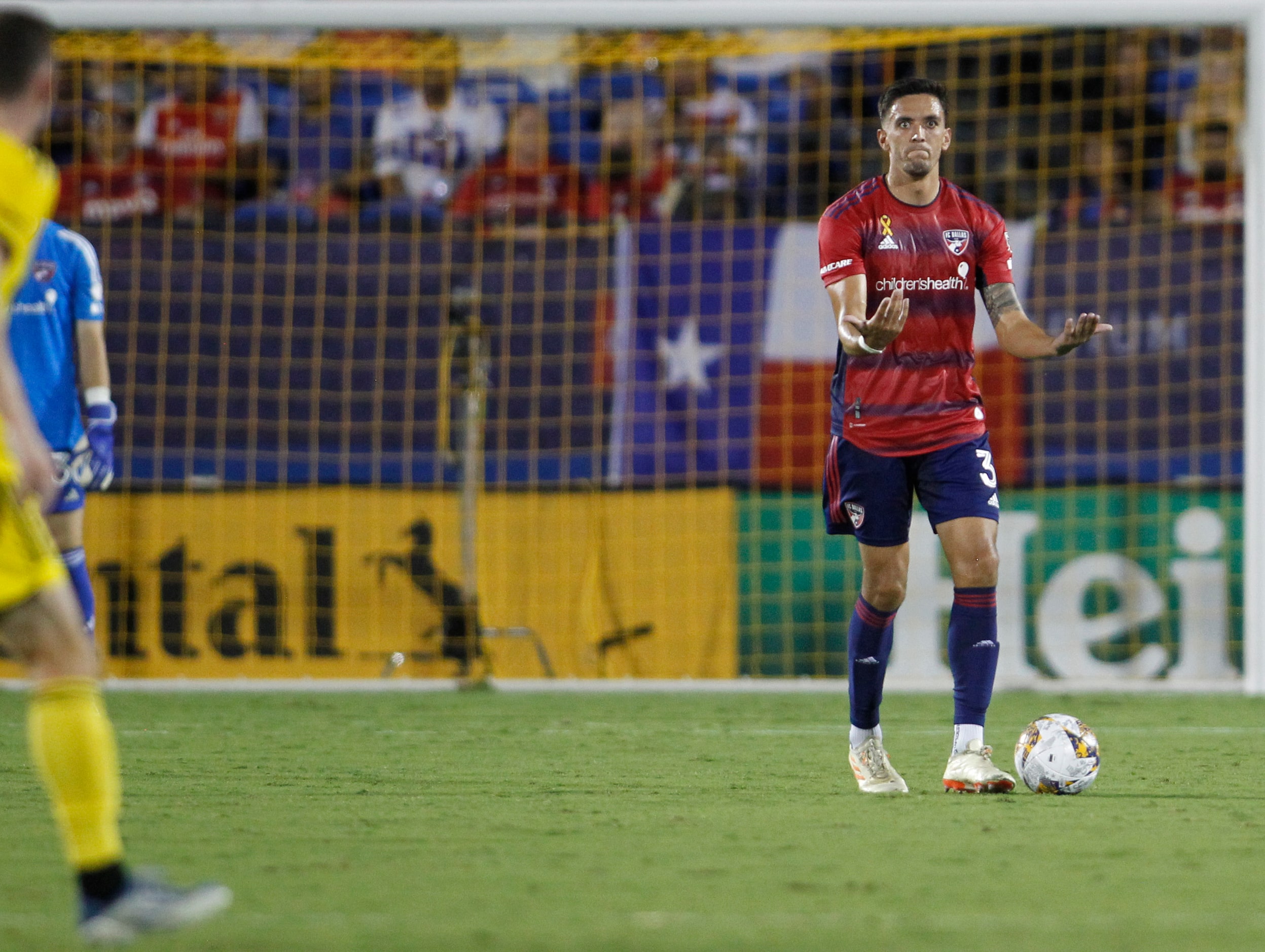 FC Dallas defender Jose Martinez (3) gestures to teammates during first half play against...