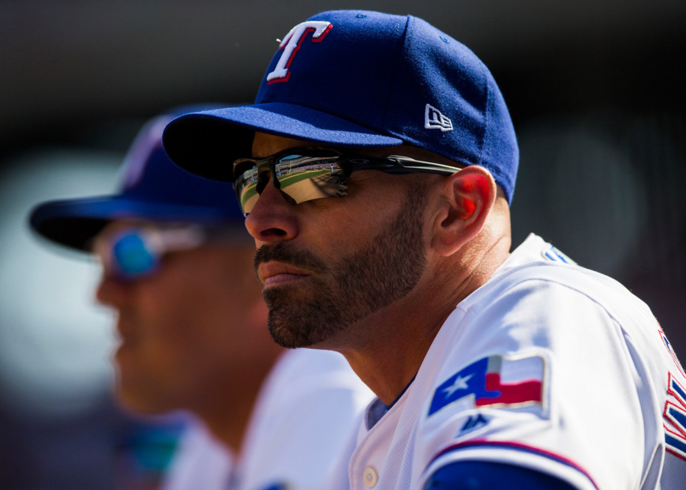 Texas Rangers manager Chris Woodward (8) watches the game from the dugout during the fifth...