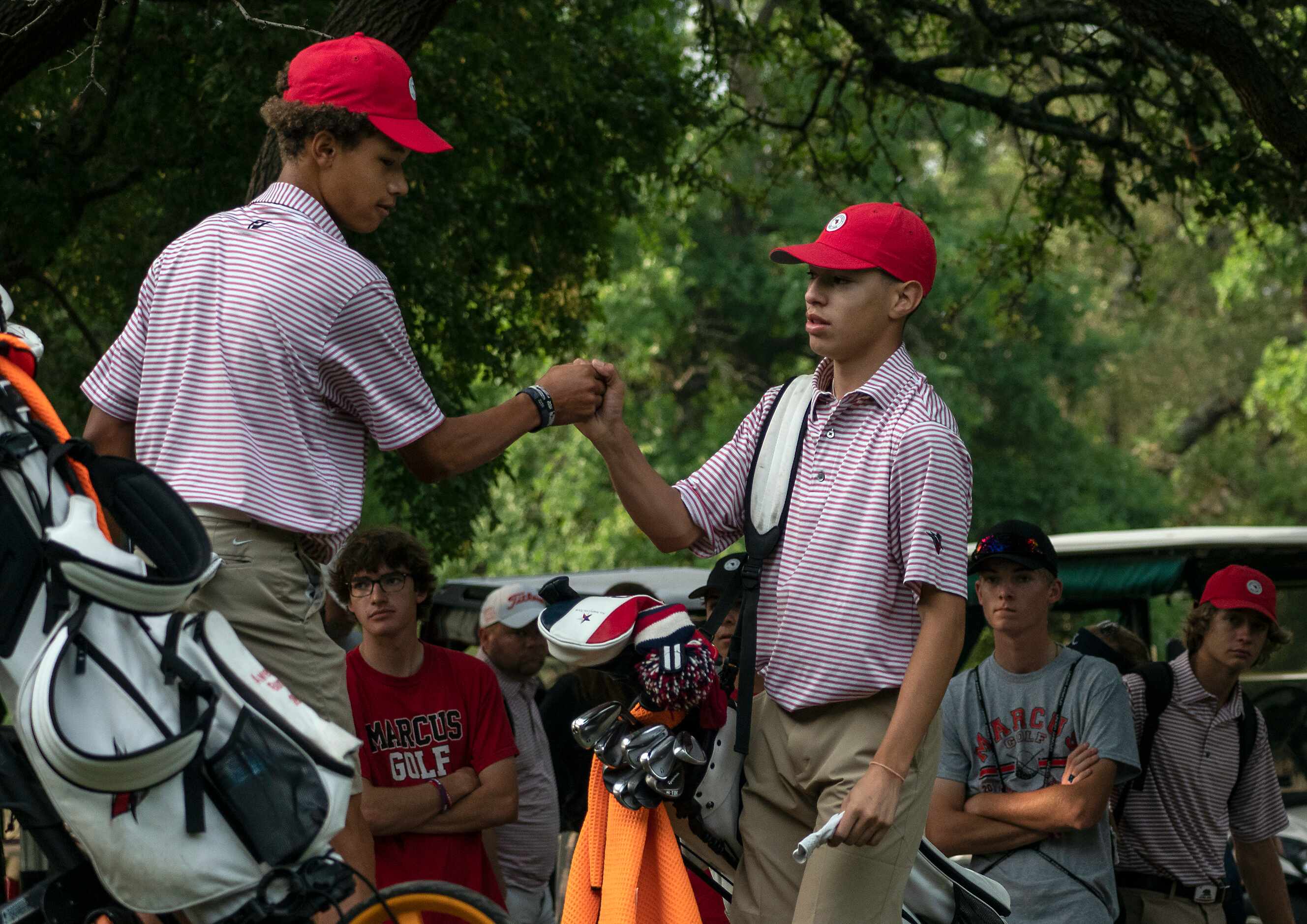 Flower Mound Marcus, Awesome Burnett and Kenneth Melendrez fist bump near the no.1 tee box...