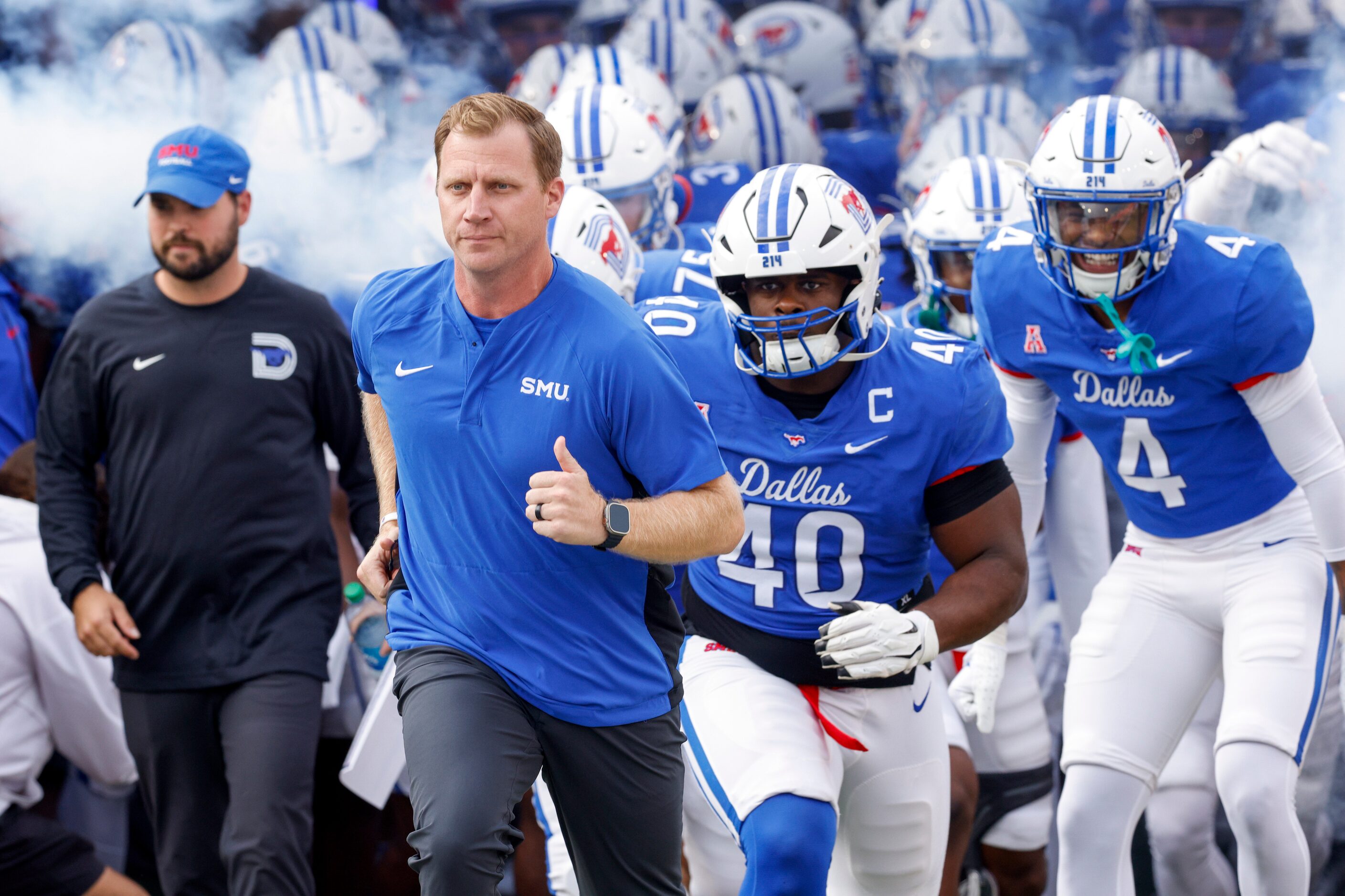 SMU head coach Rhett Lashlee leads his team onto the field before an NCAA football game...