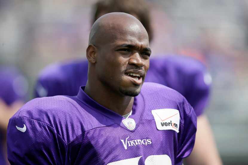 FILE - This July 31, 2014, file photo shows Minnesota Vikings running back Adrian Peterson...