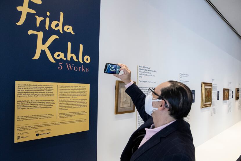 Consul General of Mexico Francisco de la Torre Galindo takes a photo of the exhibit “Frida...