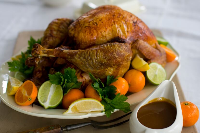 This Oct. 13, 2011 photo shows a citrus soy sauce turkey with gravy in Concord, N.H.  This...
