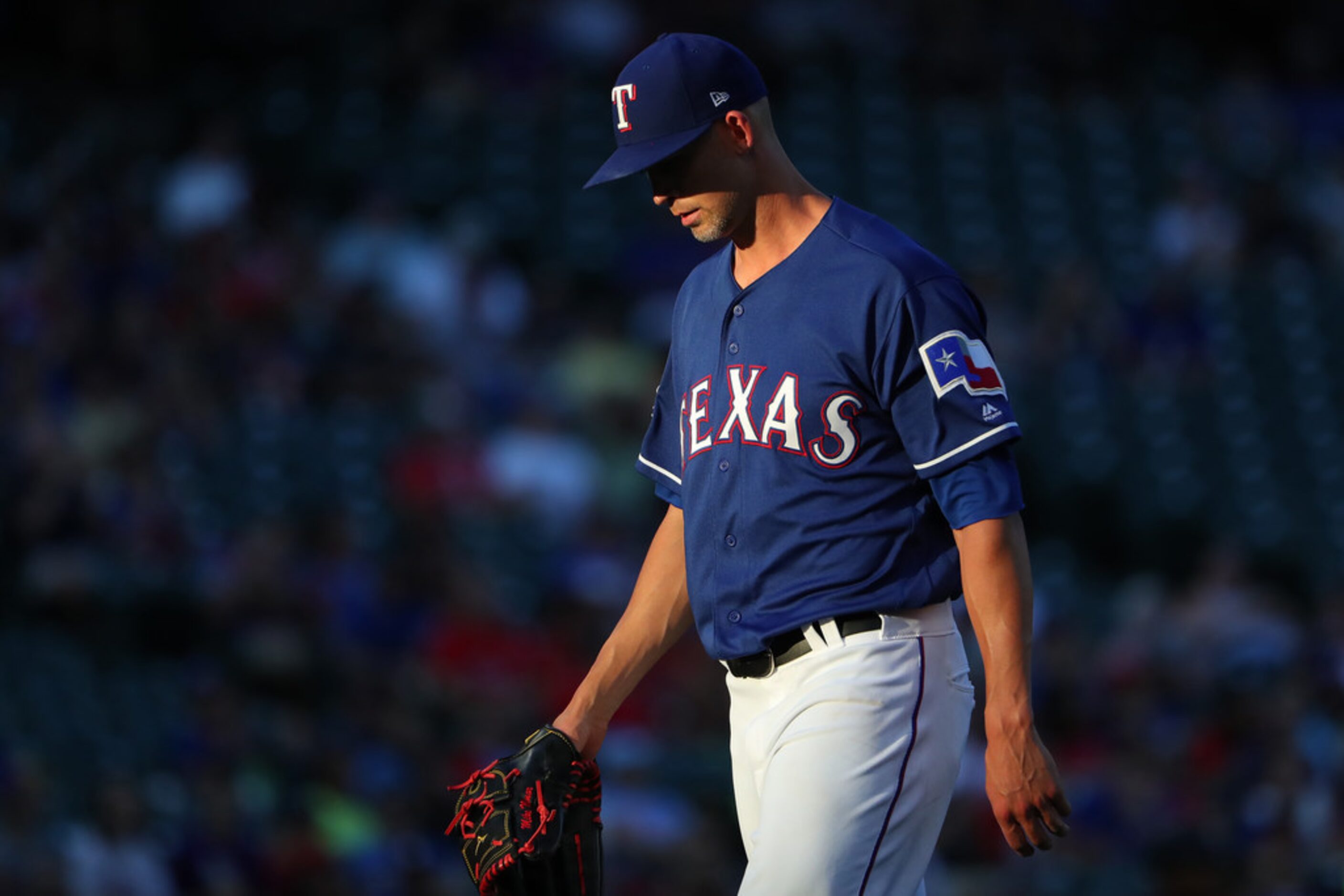 ARLINGTON, TEXAS - AUGUST 16: Mike Minor #23 of the Texas Rangers walks off the mound after...