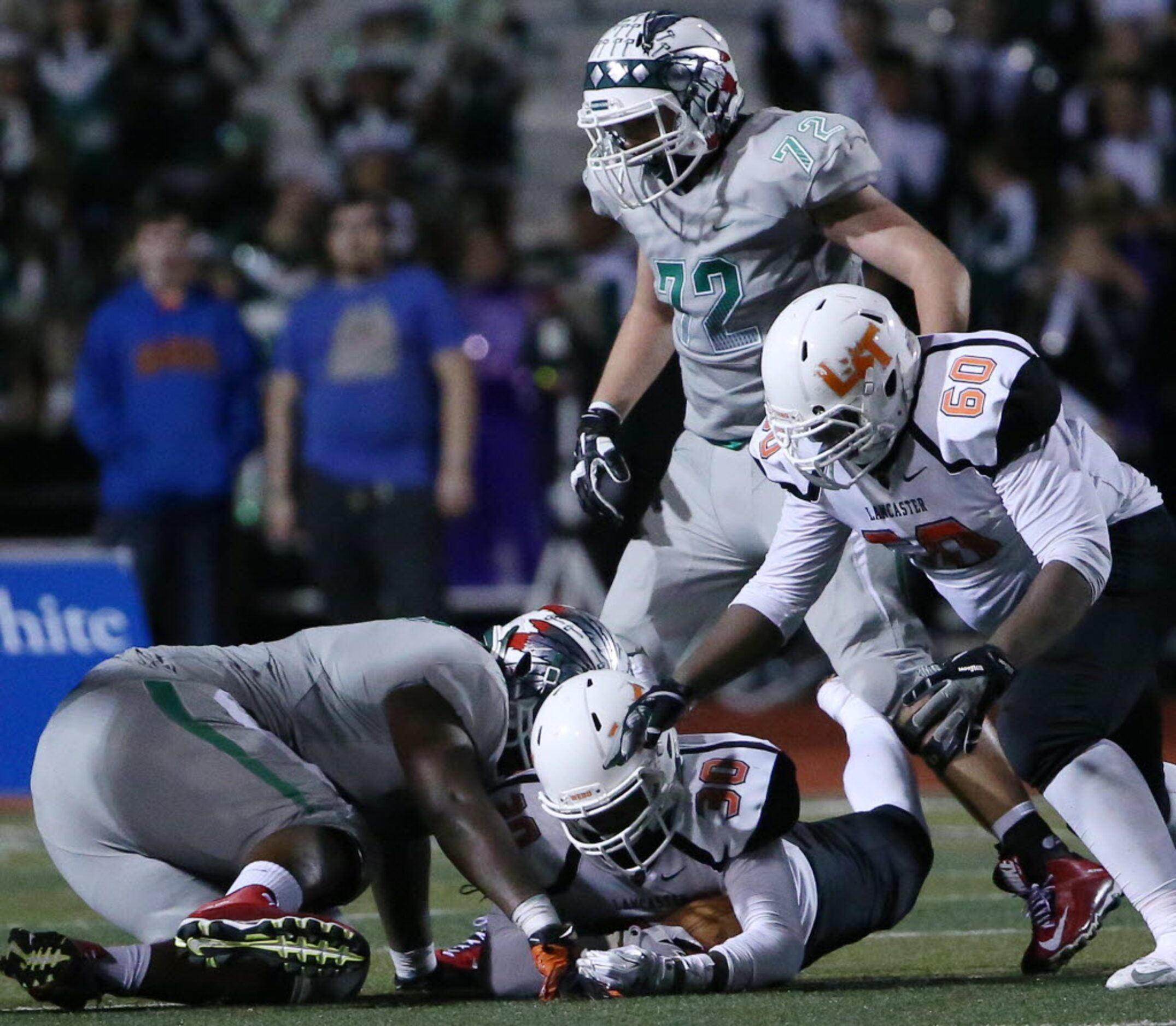 Lancaster linebacker Ahndre Hughes (30) recovers a Waxahachie fumble in the fourth quarter...