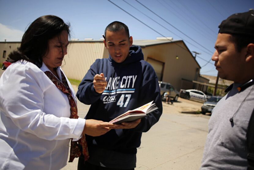 City Council member Monica Alonzo looked at graffiti designs by artist Jacob Ortega (center)...