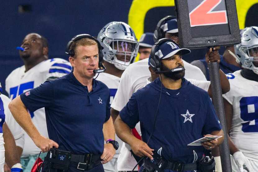 Dallas Cowboys head coach Jason Garrett and assistant coach Kris Richard stand on the...