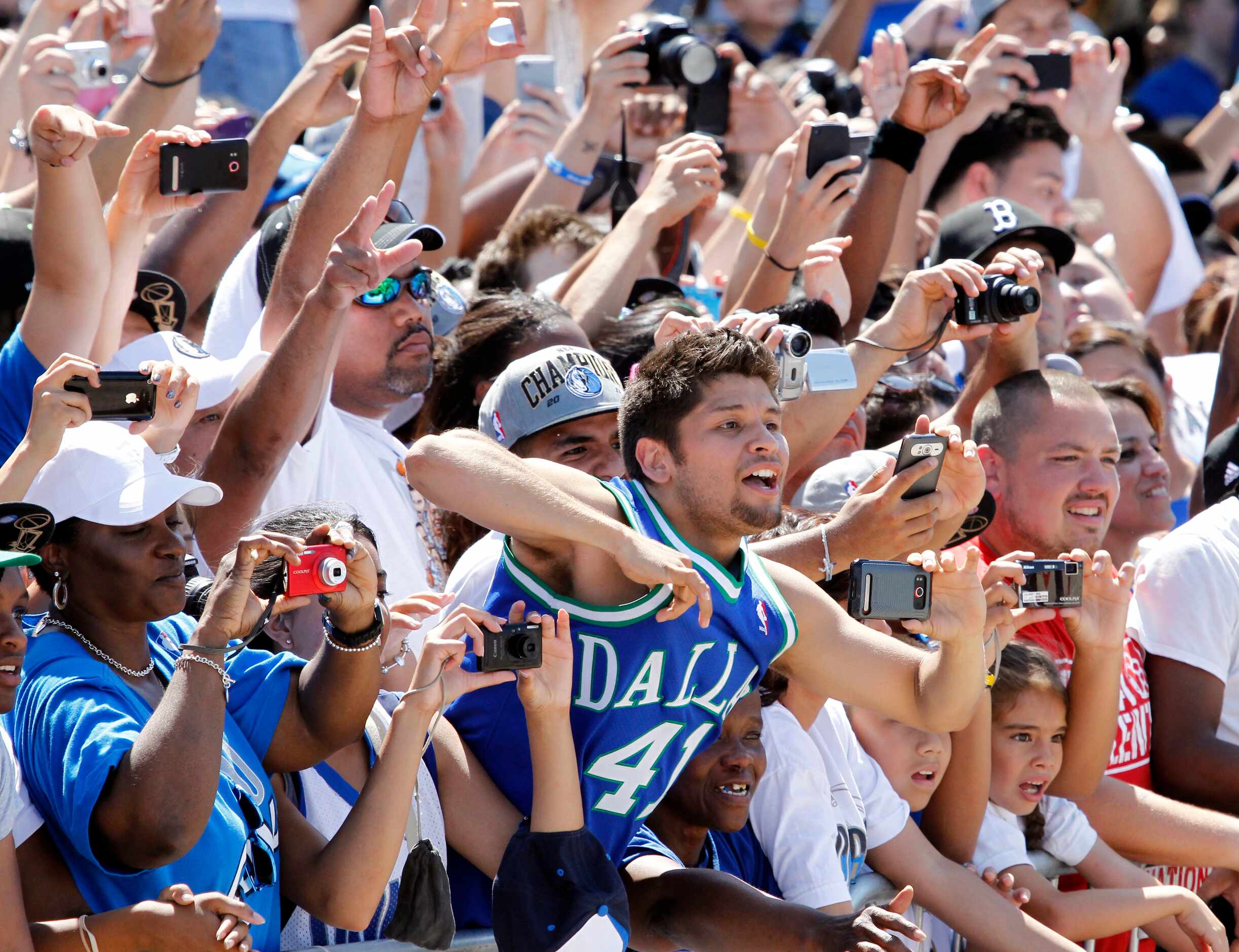 Fans clamor for photos along the parade route near the American Airlines Center during the...