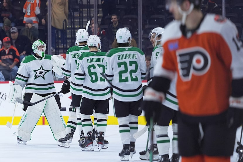 Dallas Stars' Casey DeSmith, left, celebrates with teammates after the Stars won an NHL...