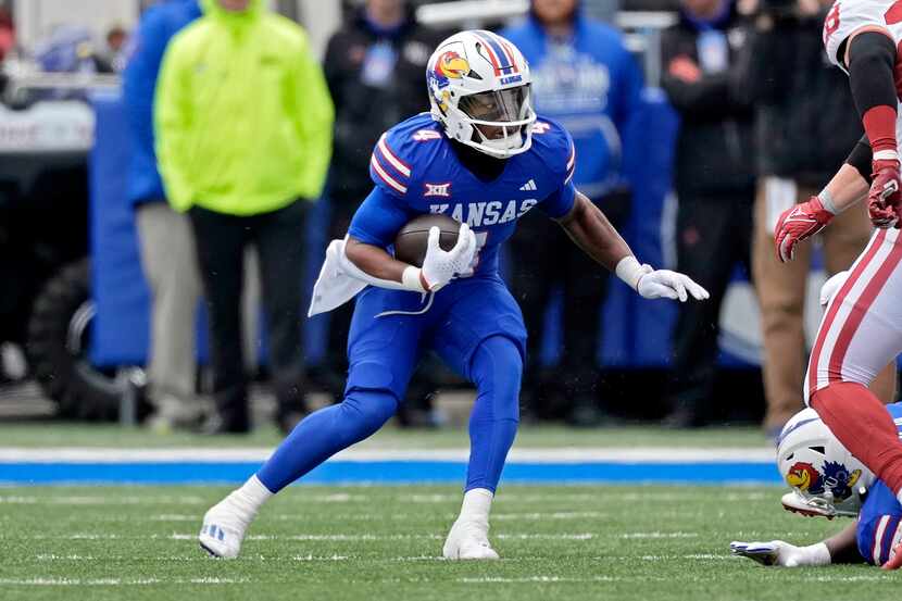 Kansas running back Devin Neal runs the ball during the first half of an NCAA college...