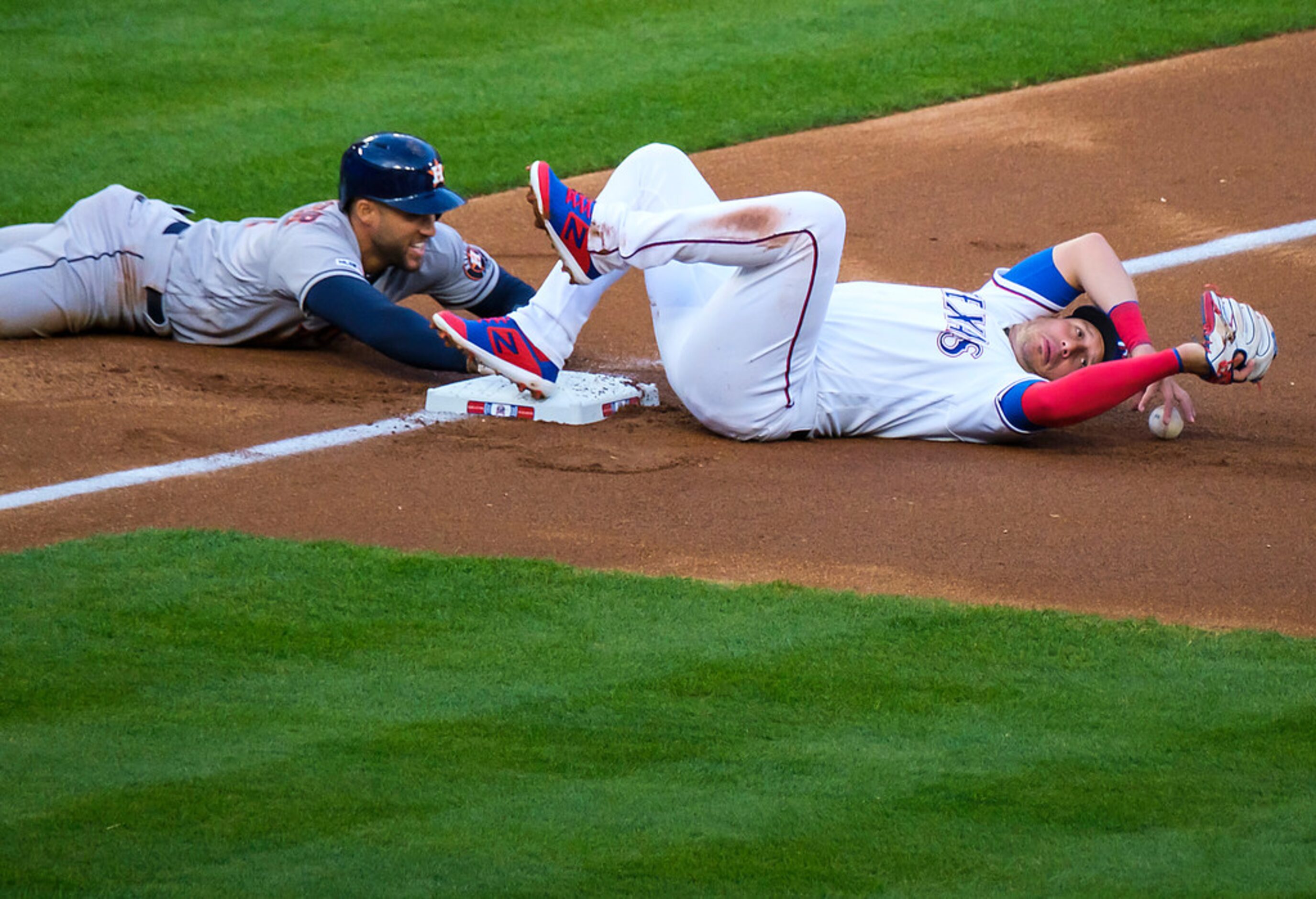 Houston Astros center fielder George Springer is safe with a stolen base as the throw gets...