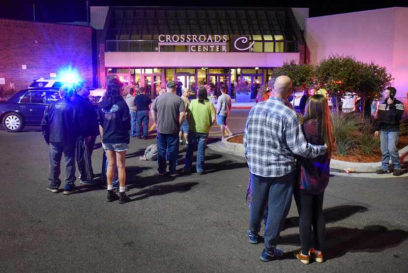 People stand near the entrance on the north side of Crossroads Center shopping mall in St....