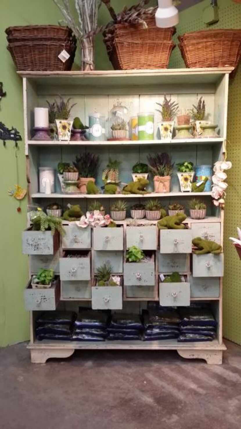 
Colorful cabinets and seaside-inspired shelves at the multilevel garden shop Tom's Thumb in...