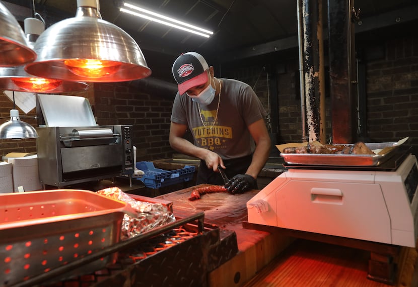 Jonny Magno cuts some meat at Hutchins BBQ in McKinney.