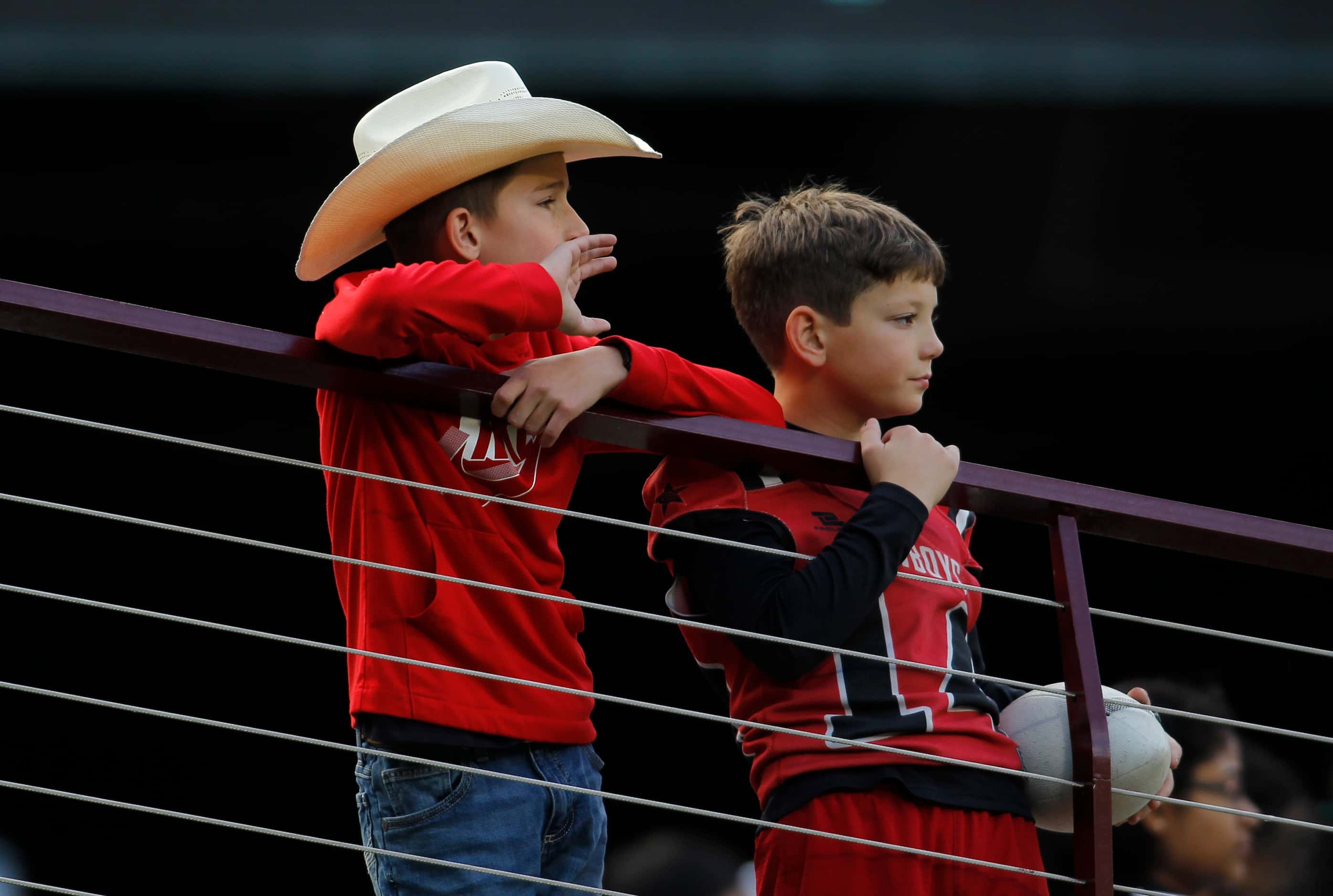 A pair of young Coppell Cowboys fans watch second quarter action of their game against Byron...