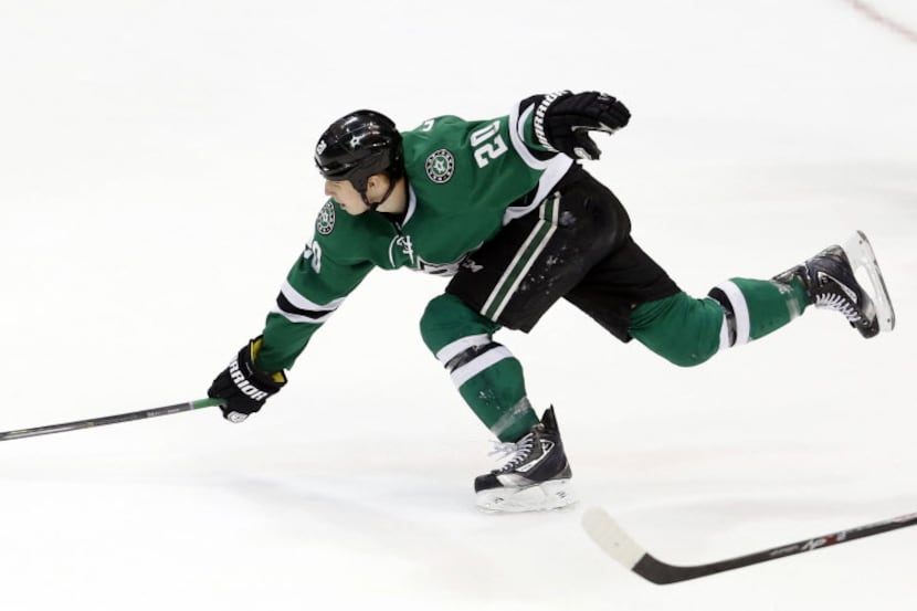 Dallas Stars center Cody Eakin (20) reaches for the puck in a game against the Phoenix...