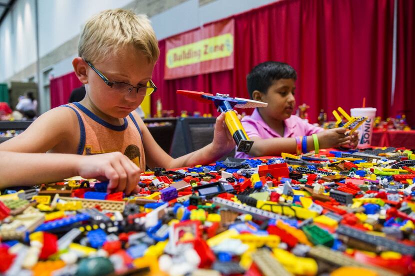 Caleb Henson (left), 7, and Kobe Mora, 8, build with LEGOs during the LEGO BrickUniverse fan...