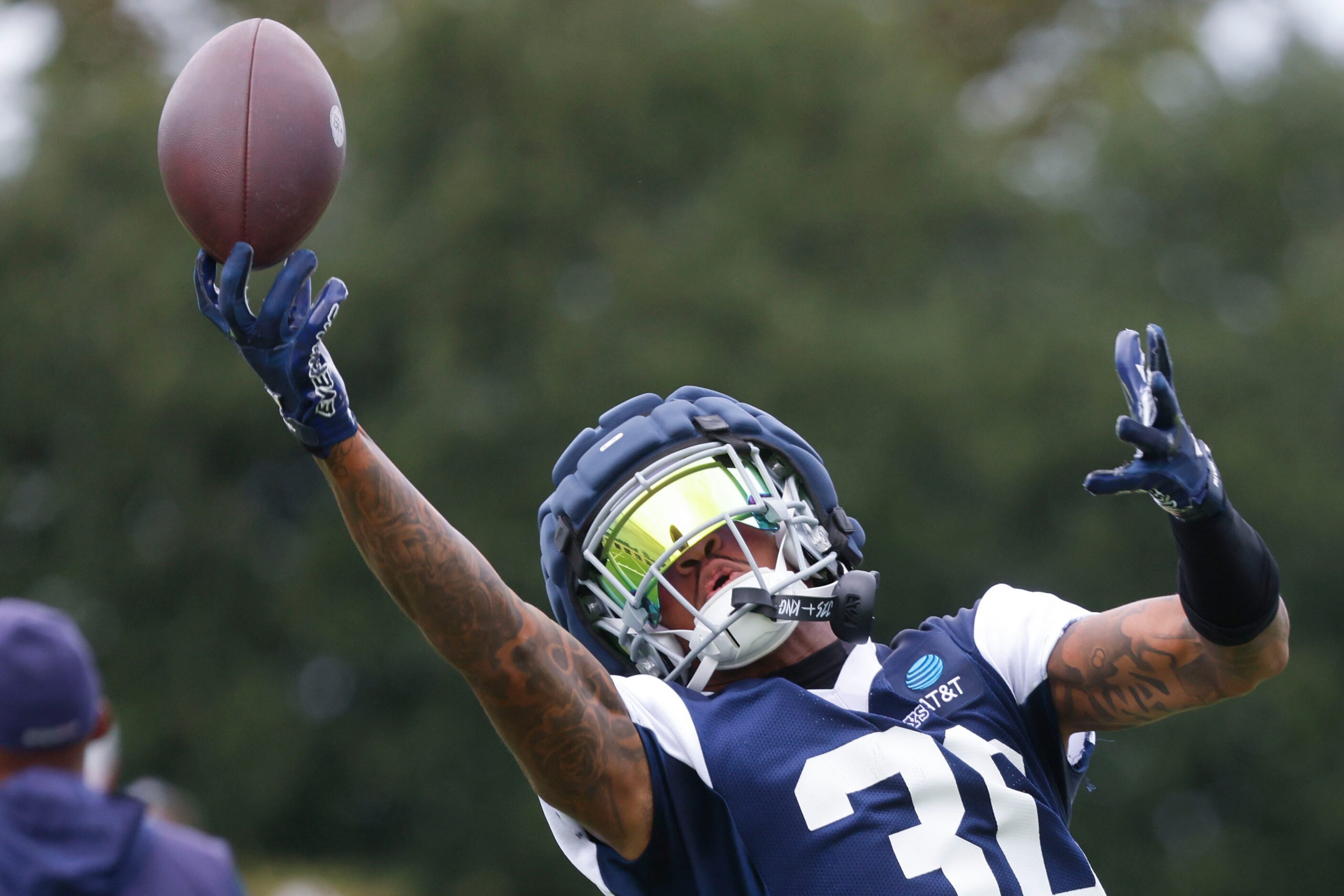 Dallas Cowboys safety Juanyeh Thomas (30) reaches to receive a throw during a team practice,...