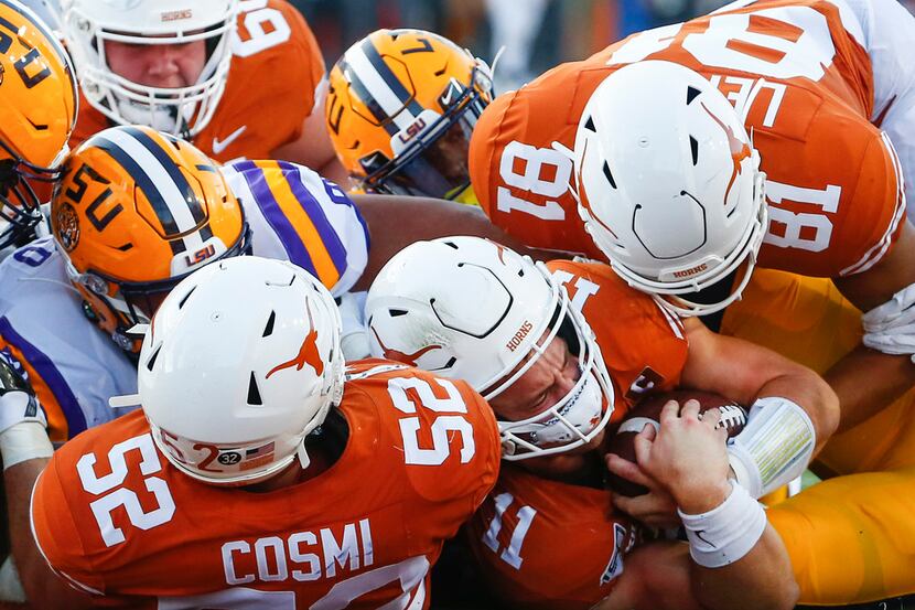 Texas Longhorns quarterback Sam Ehlinger (11) fails to score as he is brought down by LSU...