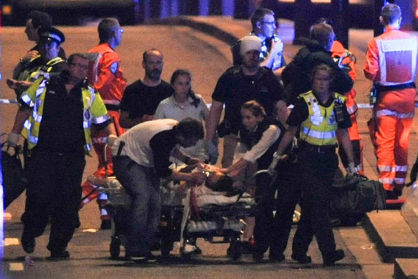 Police and members of the emergency services attend to victims of a terror attack on London...