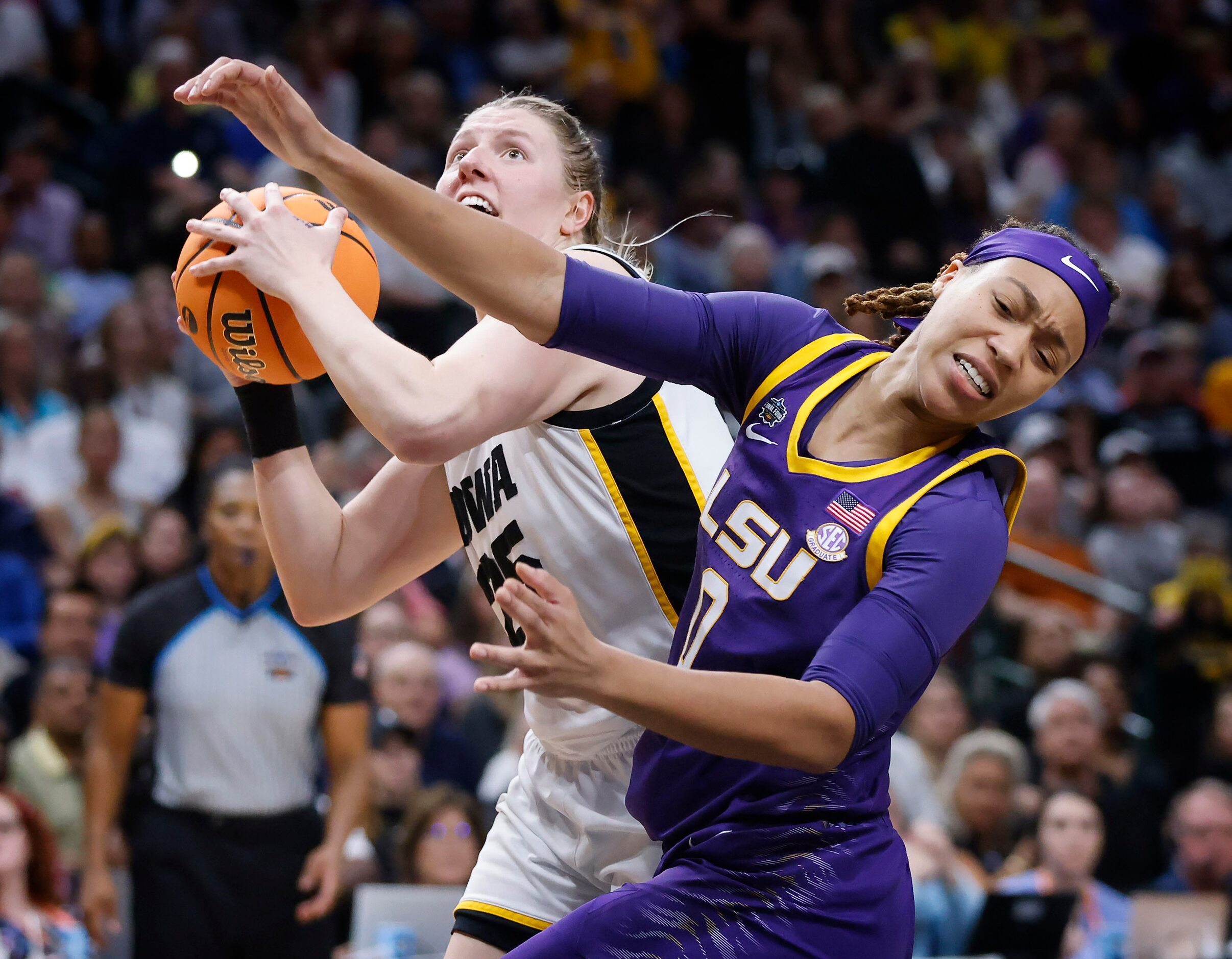 LSU Lady Tigers forward LaDazhia Williams (0) recoils after being elbowed by Iowa Hawkeyes...