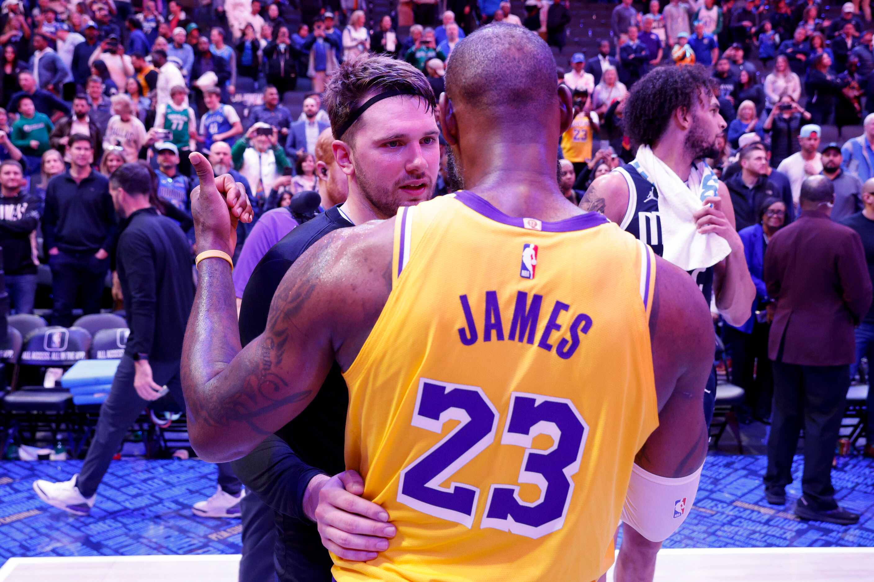 Los Angeles Lakers forward LeBron James (23) talks with Dallas Mavericks guard Luka Doncic...
