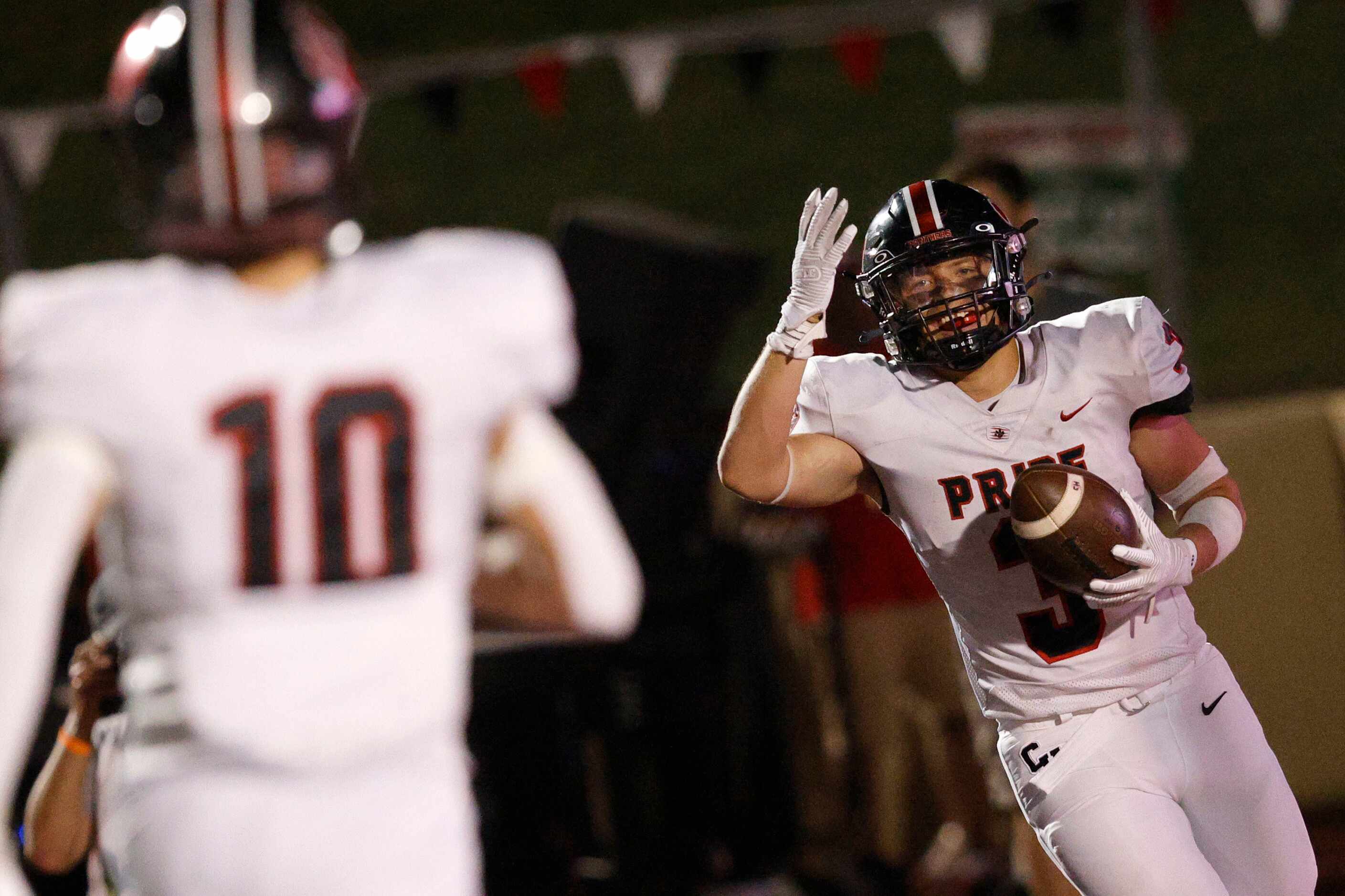 Colleyville Heritage's Ryan Keleher (3) celebrates his touchdown with Colleyville Heritage's...