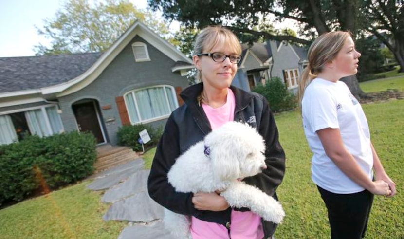 
Libby Franks, her dog, Lola, and Kara Lutley watched the activity down the street in the...