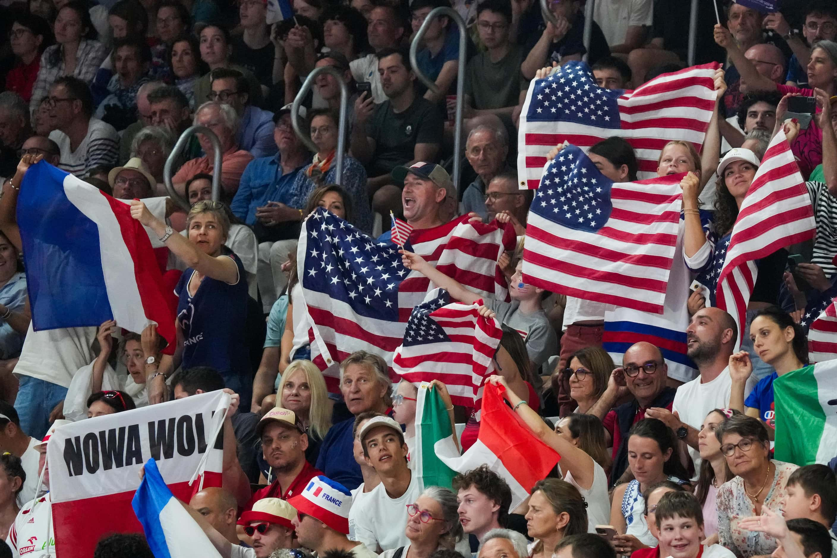 Fans cheer during a men’s volleyball semifinal between the United States and Poland at the...